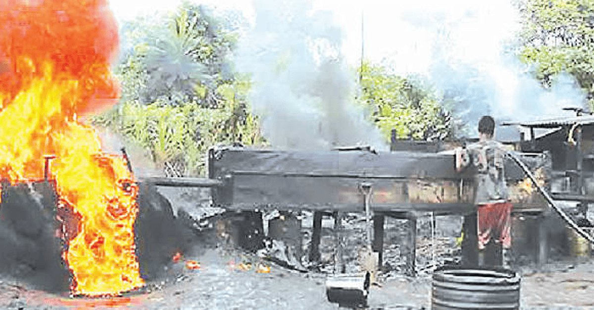 Nigerian Navy officers inspect seized drums of illegal diesel at a depot in Rivers State.