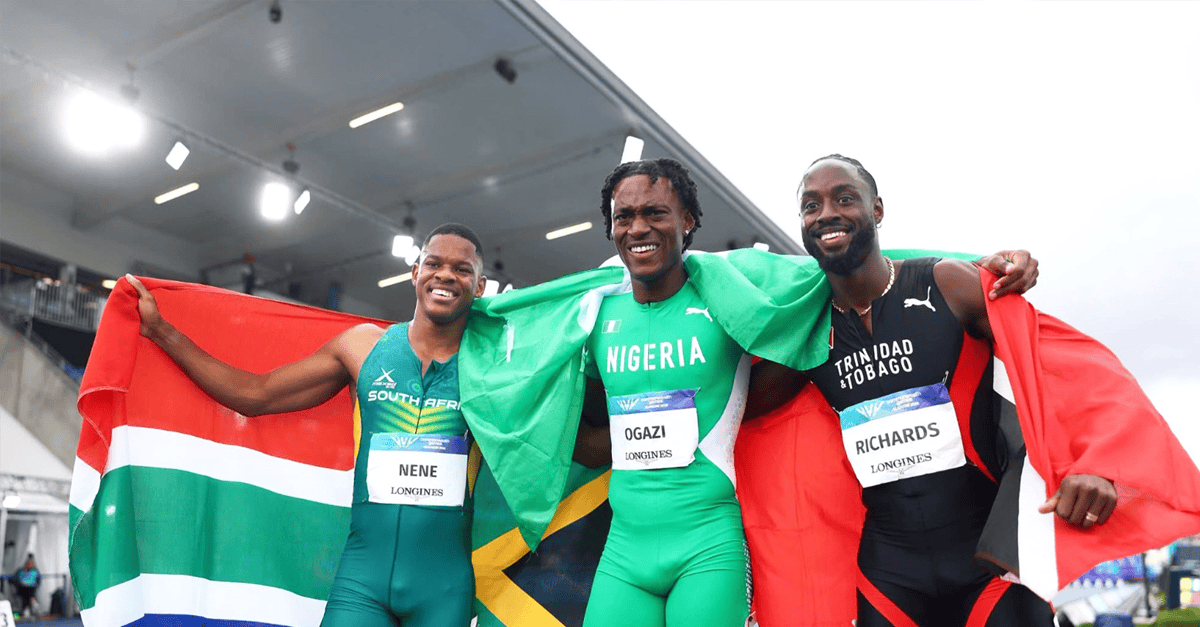 Samuel Ogazi celebrating with Nigerian flag on Glasgow track